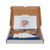 Image of the gluten-free and dairy-free gingerbread house kit box with the contents